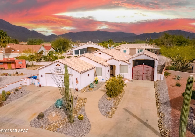 mediterranean / spanish home featuring a garage and a mountain view