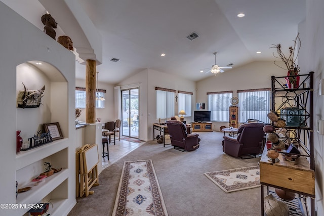 living room with ornate columns, lofted ceiling, light carpet, and ceiling fan