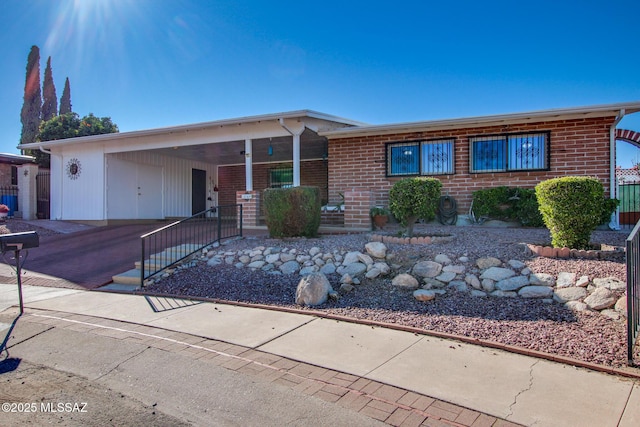 ranch-style house featuring a carport