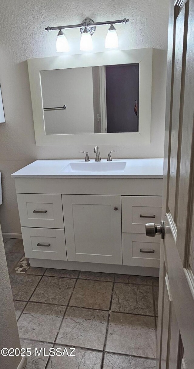 unfurnished bedroom featuring dark carpet, sink, and a closet