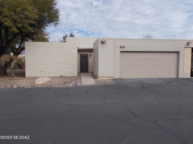 pueblo-style house featuring a garage