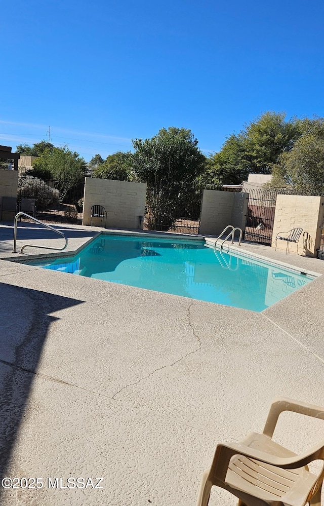 view of swimming pool featuring a patio