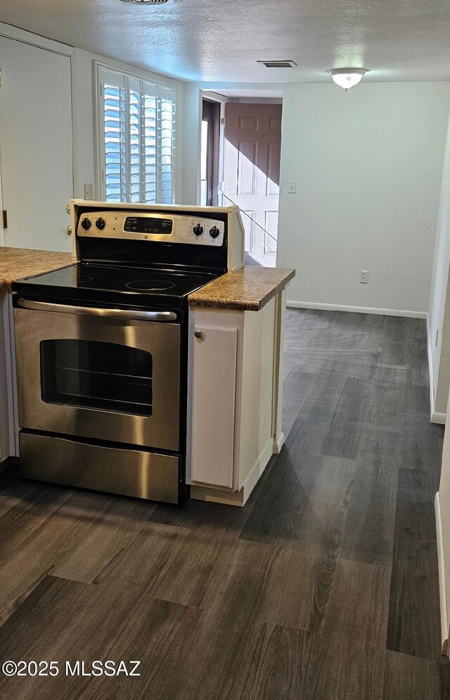 kitchen with sink, white cabinetry, stainless steel appliances, and dark wood-type flooring