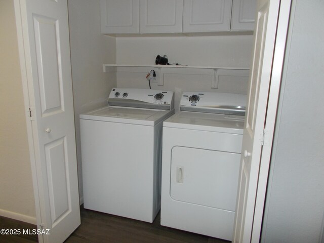 clothes washing area featuring washer and dryer, cabinets, and dark wood-type flooring