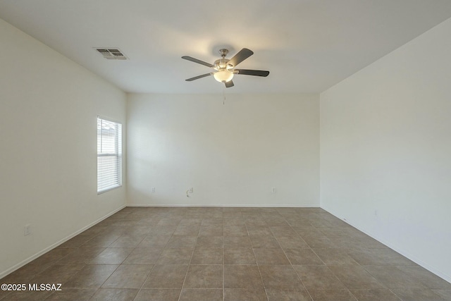 empty room featuring light tile patterned flooring and ceiling fan