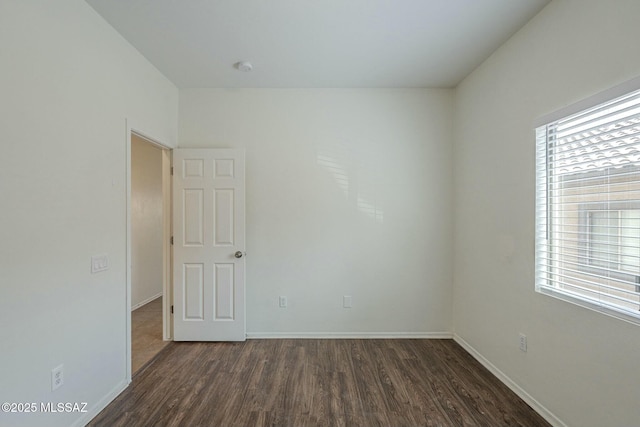 unfurnished room featuring dark hardwood / wood-style flooring