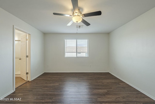 empty room featuring ceiling fan and dark hardwood / wood-style flooring