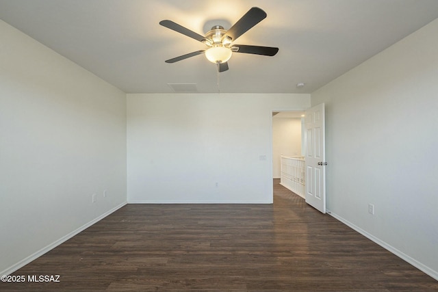 unfurnished room with ceiling fan and dark hardwood / wood-style flooring