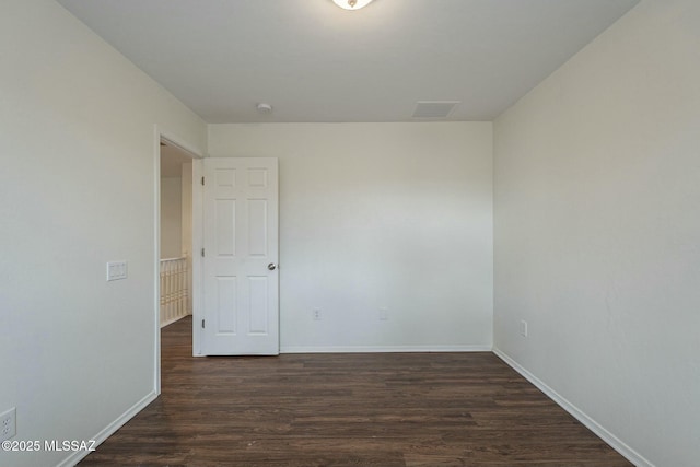 spare room with dark hardwood / wood-style flooring