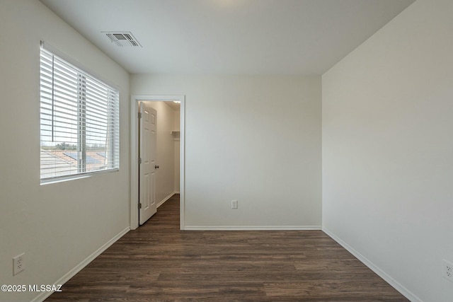 unfurnished room featuring dark wood-type flooring