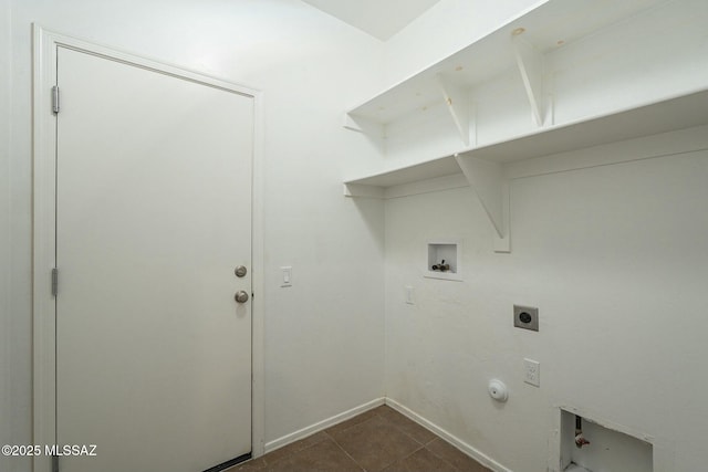 laundry area featuring hookup for a gas dryer, hookup for a washing machine, dark tile patterned flooring, and electric dryer hookup