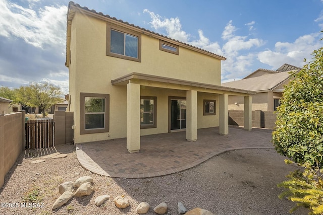 back of property featuring a patio