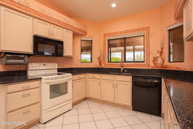 kitchen with light tile patterned floors, sink, dark stone countertops, and black appliances