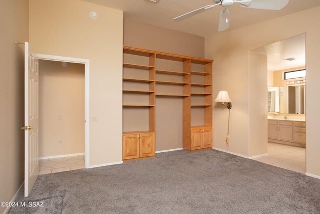 unfurnished bedroom with light carpet, a closet, ceiling fan, and ensuite bathroom