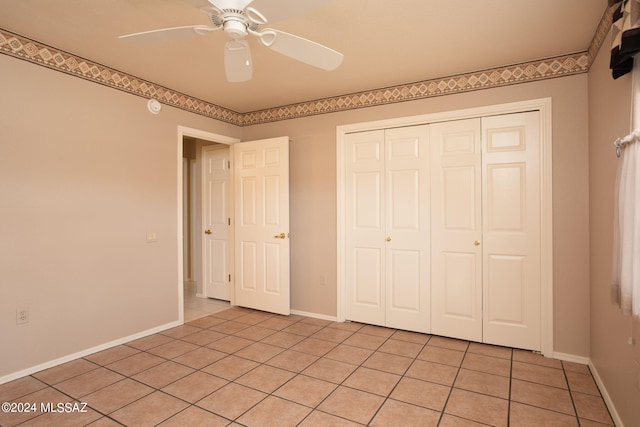 unfurnished bedroom with a closet, ceiling fan, and light tile patterned flooring