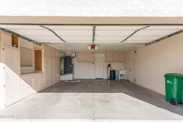 garage with sink, a garage door opener, and water heater