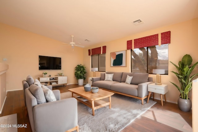 living room featuring hardwood / wood-style floors and ceiling fan