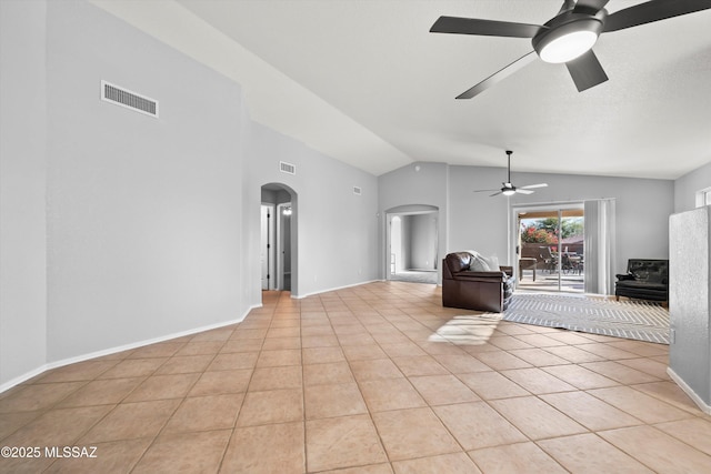 unfurnished living room with ceiling fan, lofted ceiling, and light tile patterned flooring