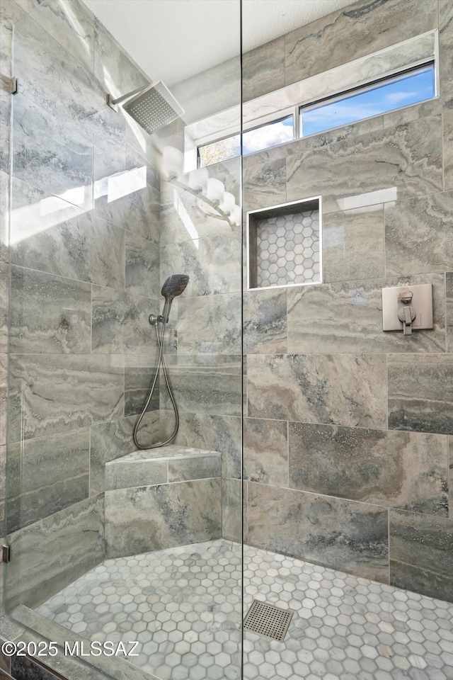 bathroom with a tile shower