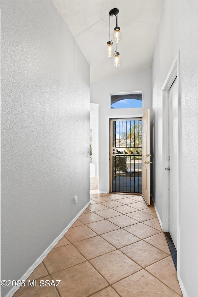 entrance foyer featuring light tile patterned floors and lofted ceiling