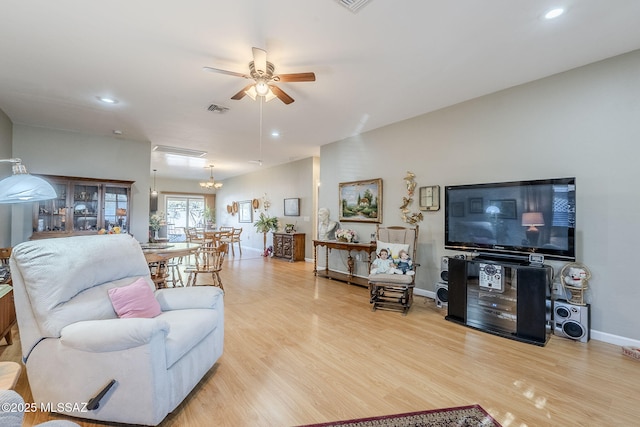 living room featuring light wood-type flooring and ceiling fan