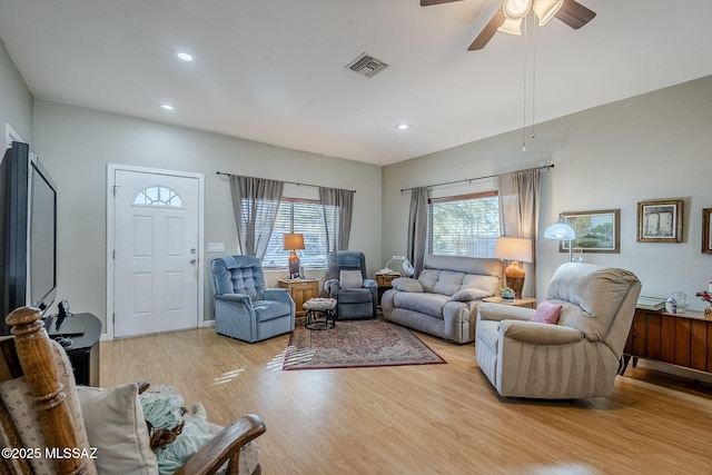 living room featuring ceiling fan and light wood-type flooring