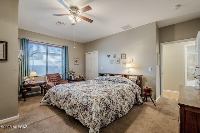 bedroom featuring ceiling fan, a closet, and light carpet