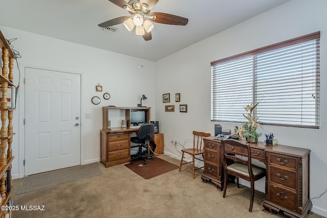 carpeted office space with ceiling fan