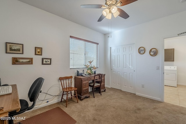 office area featuring light carpet, ceiling fan, and washer / dryer