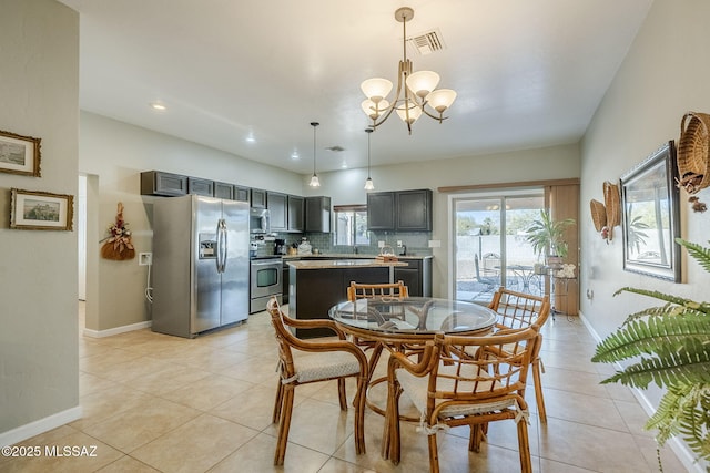 tiled dining area with an inviting chandelier