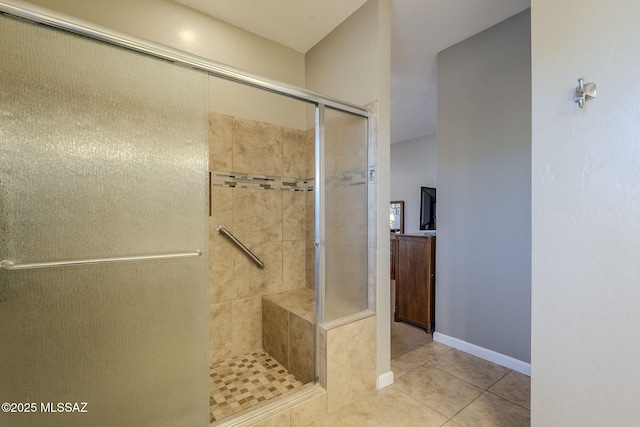 bathroom featuring tile patterned flooring and a shower with shower door