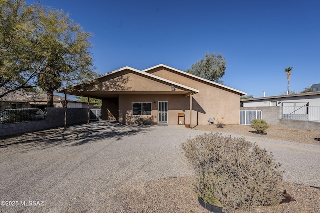 ranch-style home featuring a carport