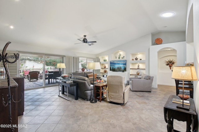 living room featuring built in shelves, ceiling fan, and lofted ceiling