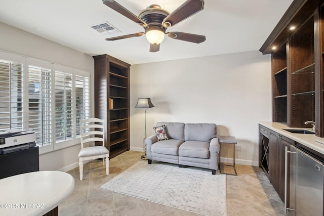 living room featuring sink and ceiling fan