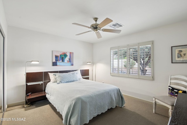 bedroom featuring ceiling fan and carpet