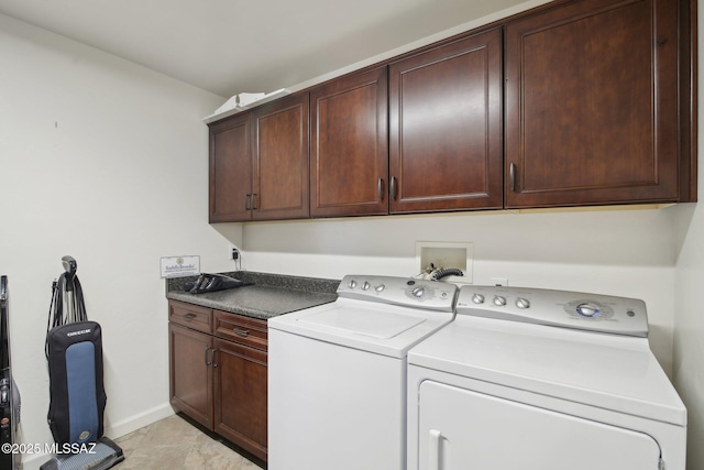 laundry area featuring light tile patterned floors, cabinets, and independent washer and dryer