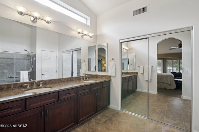 bathroom featuring vaulted ceiling, ceiling fan, and vanity