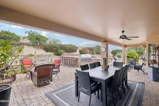 view of patio featuring area for grilling, an outdoor bar, and ceiling fan