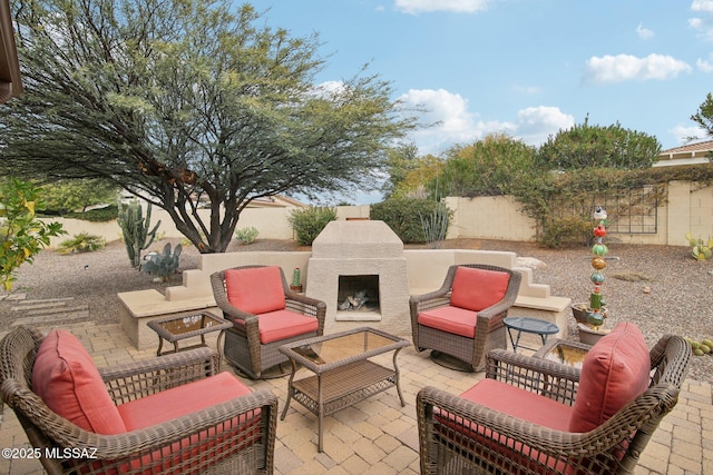 view of patio featuring an outdoor living space with a fireplace