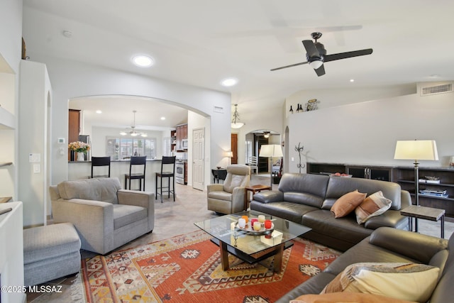 living room featuring ceiling fan, light tile patterned floors, and lofted ceiling