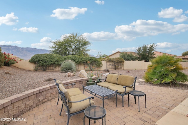 view of patio / terrace featuring a mountain view and outdoor lounge area