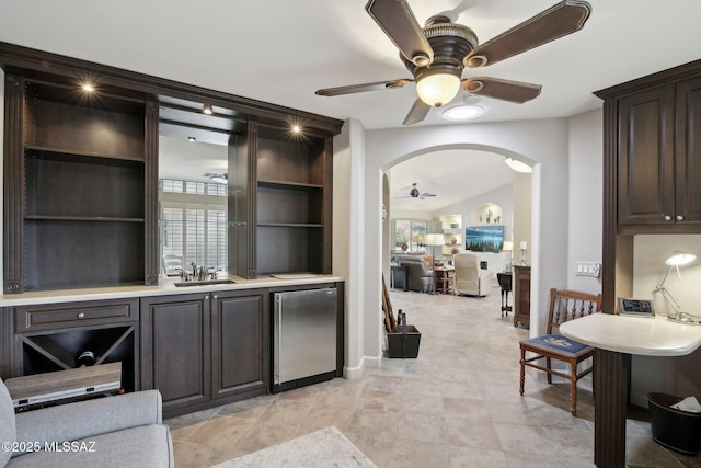 bar with ceiling fan, plenty of natural light, sink, and fridge