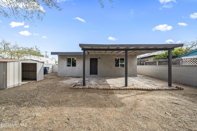 rear view of property with a shed