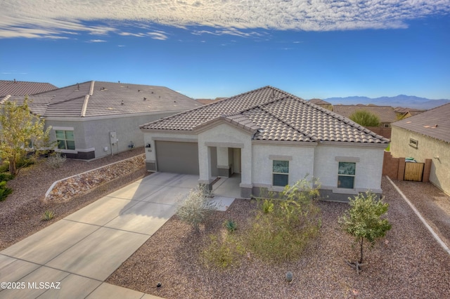 view of front of property with a mountain view and a garage