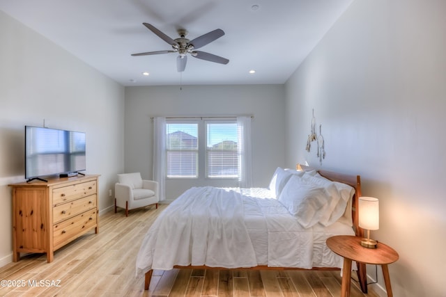 bedroom with ceiling fan and light hardwood / wood-style flooring