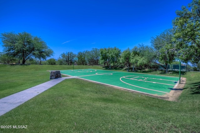 view of sport court featuring a lawn