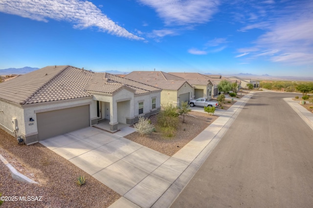 view of front of house with a mountain view and a garage