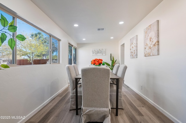 dining area featuring dark wood-type flooring