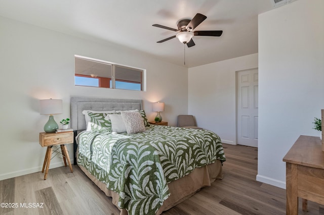 bedroom with ceiling fan and hardwood / wood-style floors