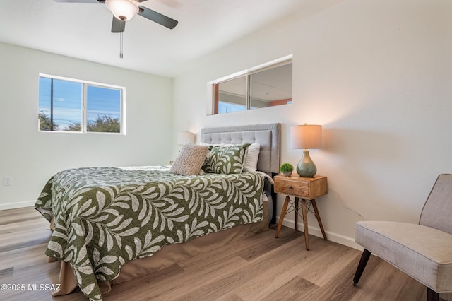 bedroom with ceiling fan and light wood-type flooring